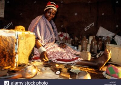 5381351_1620843286_6sangoma-traditional-healer-with-her-wares-on-street-venda-south-africa-ACBEHF